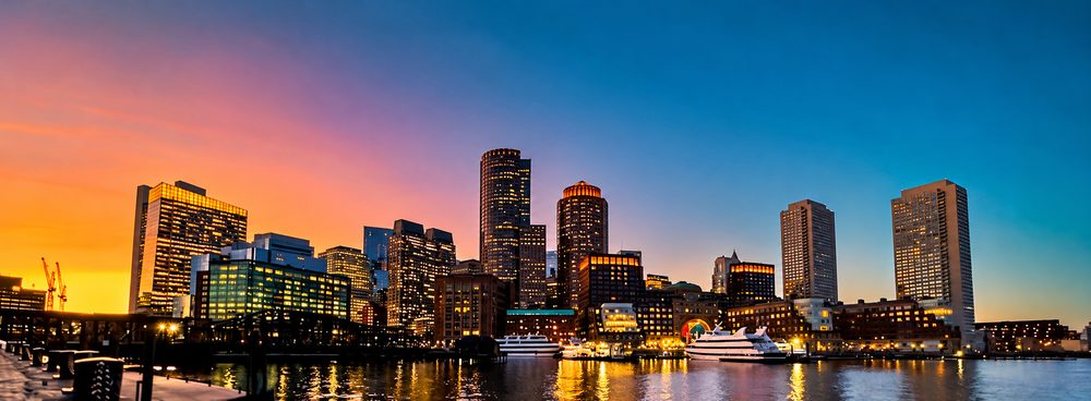 Boston skyline at sunset across the harbor, host city of the NHS 2026 Annual Meeting